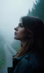 a young woman looking out the window in a foggy forest