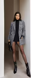 woman wearing black tights and high heeled shoes in a building