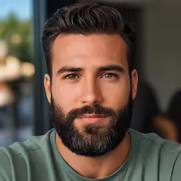 a man with beard and wearing a green shirt