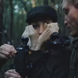 a person holding a camera up to their face