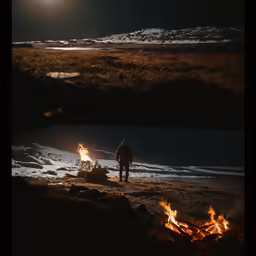 a couple of people standing next to a fire at night
