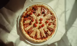 a pizza with cheese, tomatoes and toppings