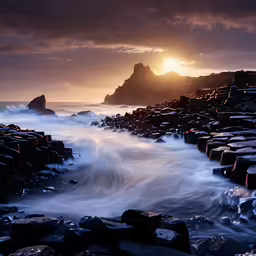 a beach with large rocks covered in foam