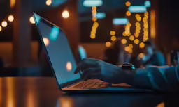 a person typing on a laptop at a table