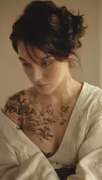 there is a woman with tattoos that are on her chest