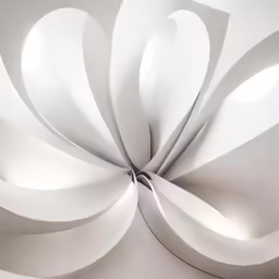 a white sculpture with several holes on it