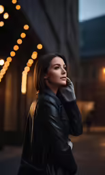 a woman in a leather jacket on the phone