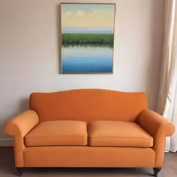 a light orange sofa in front of a painting
