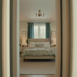 a bedroom seen through the door of another room