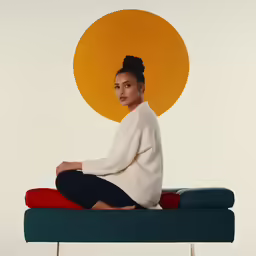the woman sits on a bench in front of a sun