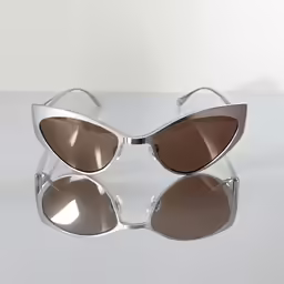 sunglasses on top of a white surface with reflecting light