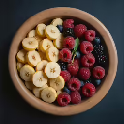 an arrangement of fruits that include bananas and raspberries
