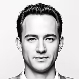 a man with a suit on posing for a photo