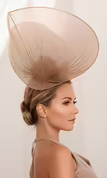 a woman with her hair in a bun wearing a hat