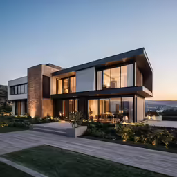 modern house at dusk with lights on