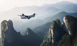 a passenger jet that is flying over mountains