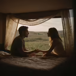 man and woman looking out of a window