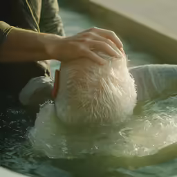 the man is putting a hat in the water