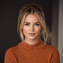 a beautiful young blonde woman posing for a picture