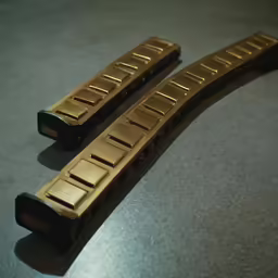 two bronze pieces of something on a table