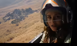 woman flying in small plane near rocky outcropping
