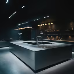 a dark kitchen with an illuminated counter and lights