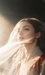 a woman with her hair flowing up by her nose