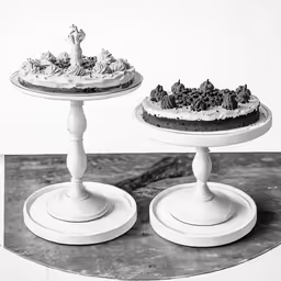 two tiered cakes on pedestals with one piece missing