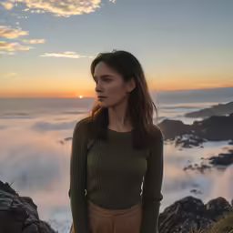 a woman standing in front of some mountains