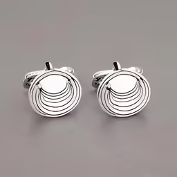 the white metal earrings is shown with circular patterns