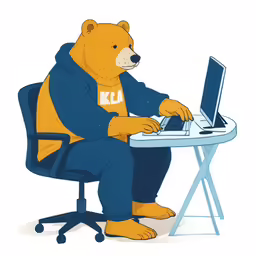 a bear sitting at a computer that has a shirt on