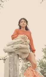 the woman is posing with some laundry