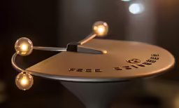 a small round stand with some lights in the background