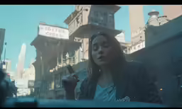 a woman in the city with a cell phone