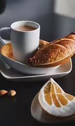 bread, fruit and a cup are on the table