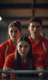 three employees with red shirts in an industrial building