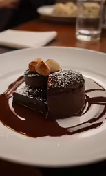 there is chocolate dessert on the plate on the table