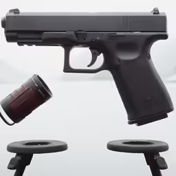 a large black gun with a cup in the air and another smaller gun on the floor next to it