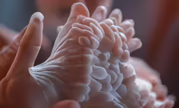 a woman holding her hands together in front of her