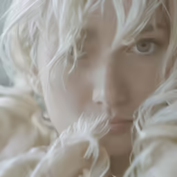 a beautiful blond woman is seen with the long white hair blowing over her shoulders