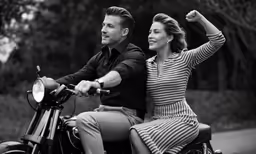 the couple is riding on a motorcycle together