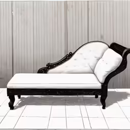 a white and black chaise lounge is set up