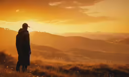 a man standing on top of a grass covered field
