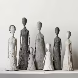a group of sculptures of different types of people