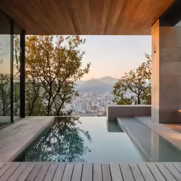 an outdoor pool with wooden boards and water features