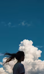 a person looking at the sky and the clouds