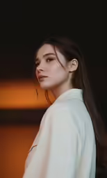 a young woman with long hair is in the light