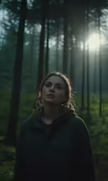 a woman with long hair standing in front of trees