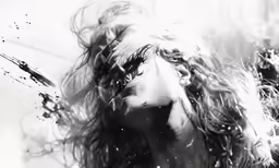 a person with long hair in the air