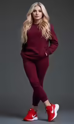 blonde girl in red sneakers posing for a studio photo